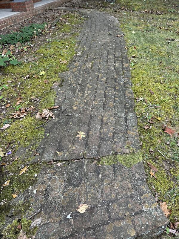 Dirty, discolored brick walkway before pressure washing